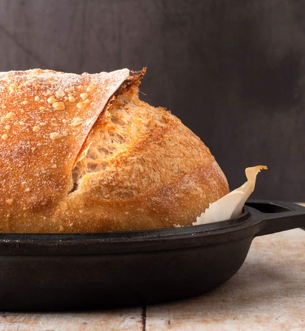 Tartine Country Loaf in black kettle showing raised ear.