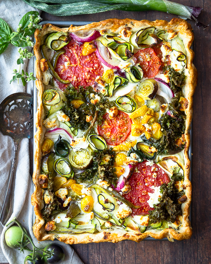 A savory garden veggie tart with tomatoes, zucchini, onion, and kale.